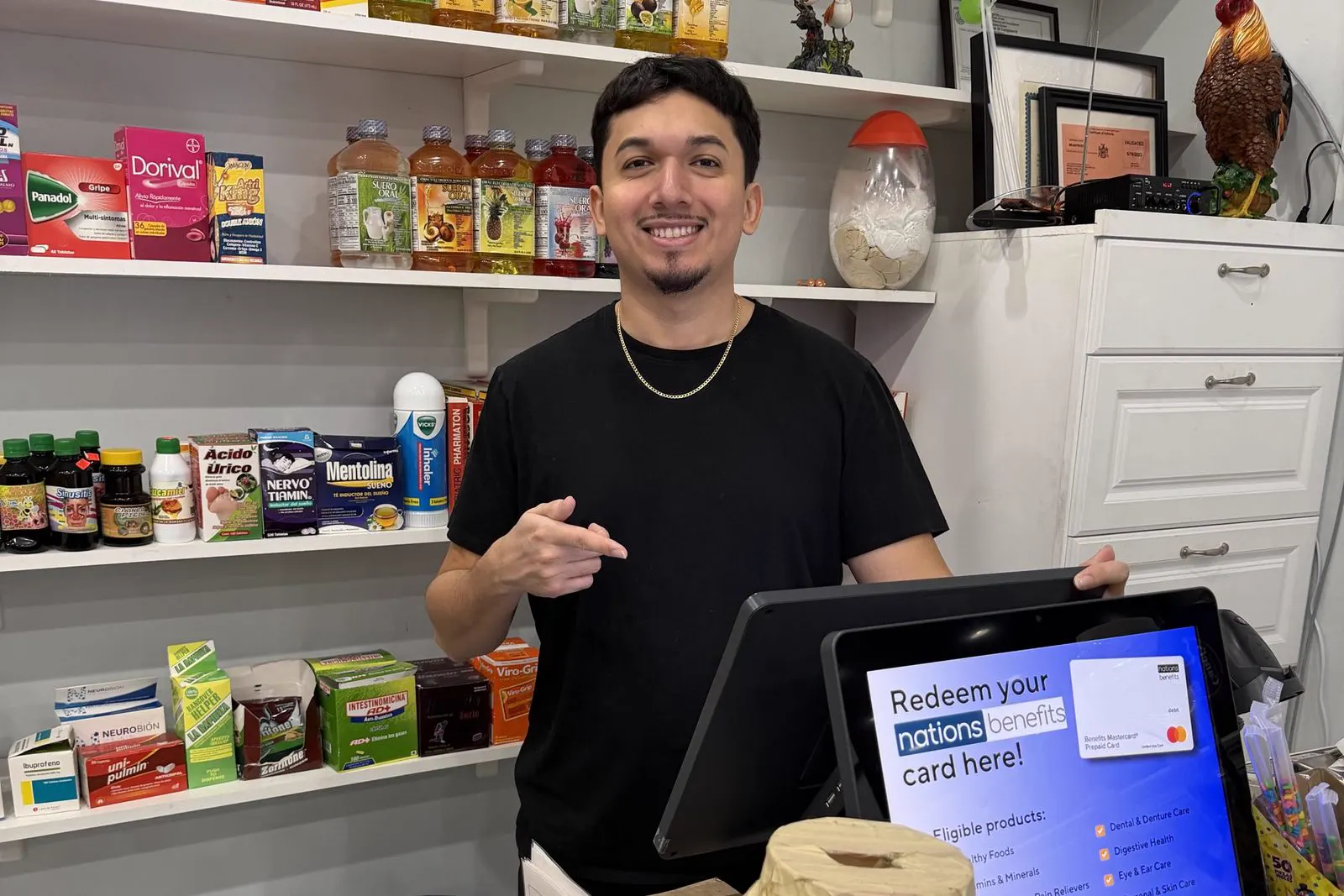 Santos Diaz helping a merchant with their point-of-sale setup